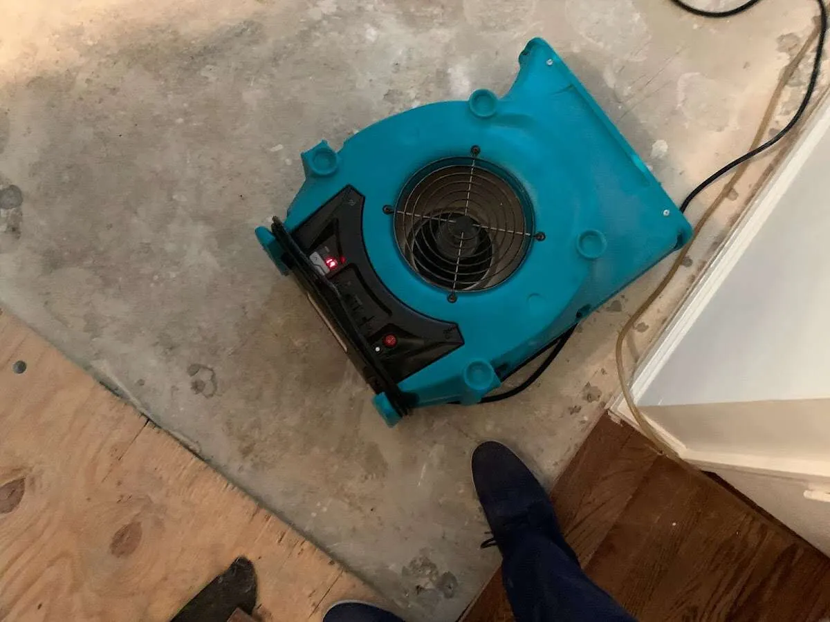 Air mover drying subfloor during Commercial Water Damage Restoration in Tabernacle